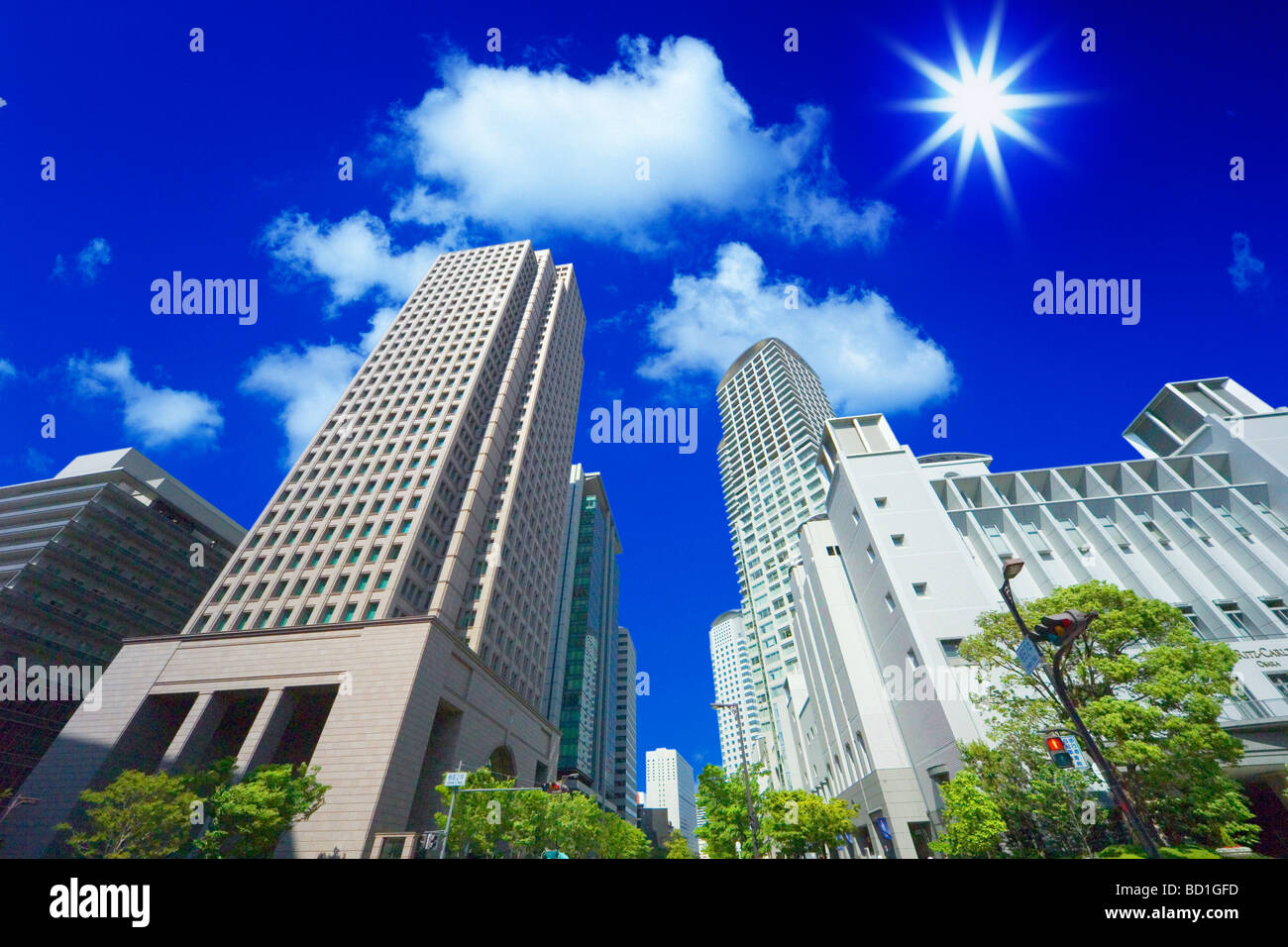 Office buildings under the blue sky in Umeda lens flare Osaka city Osaka prefecture Japan Stock Photo