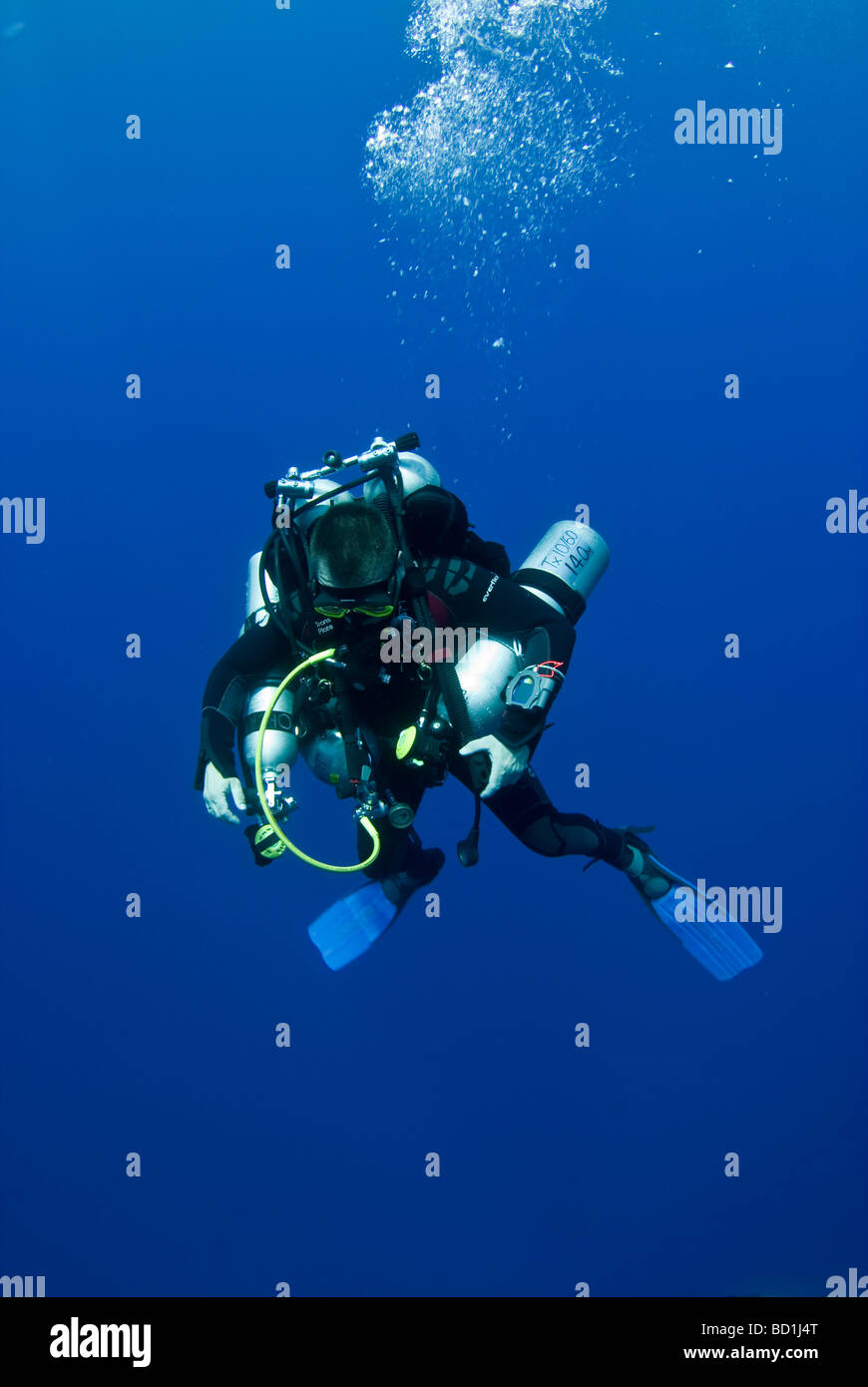 Diver surfacing from the deep. Stock Photo