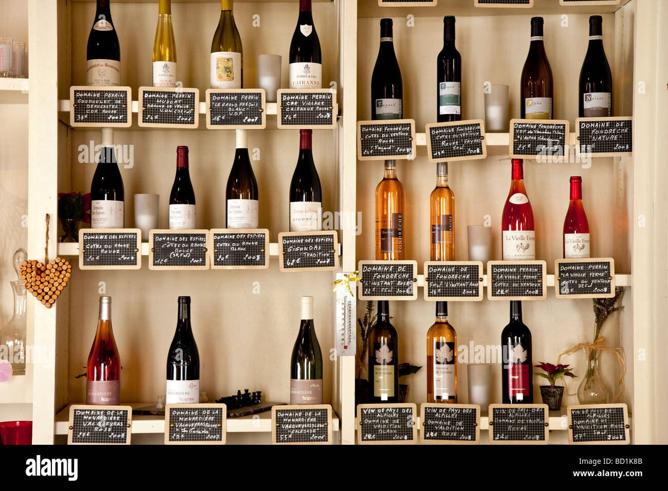 Wine bottles on Cafe shelves in Gordes, Provence France Stock Photo