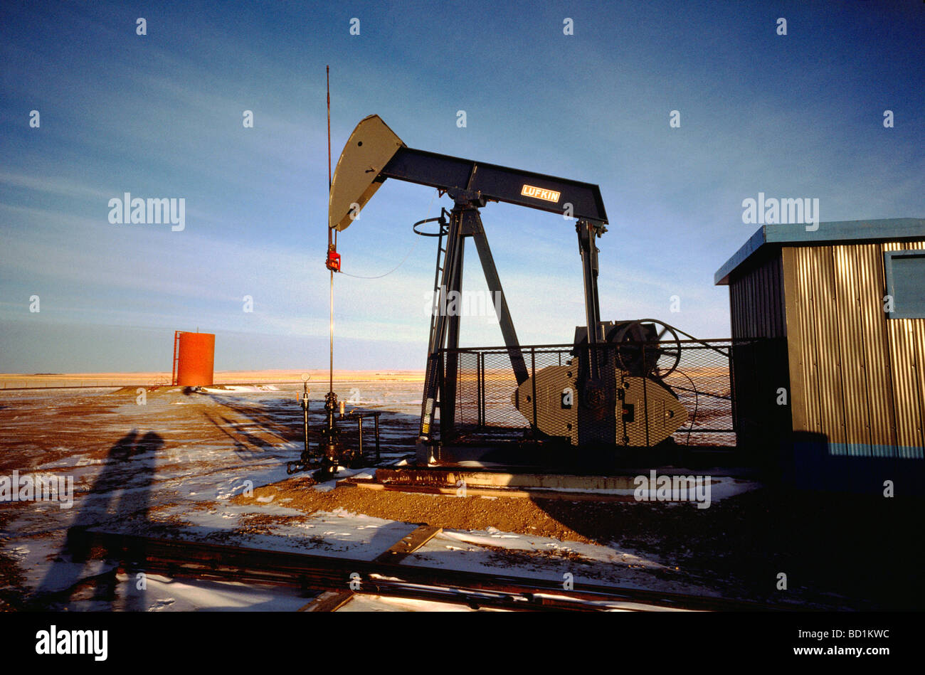 Pump Jack (Oil Donkey) pumping at Oil Well in Oil Field north of Dawson Creek, Northern British Columbia, BC, Canada Stock Photo