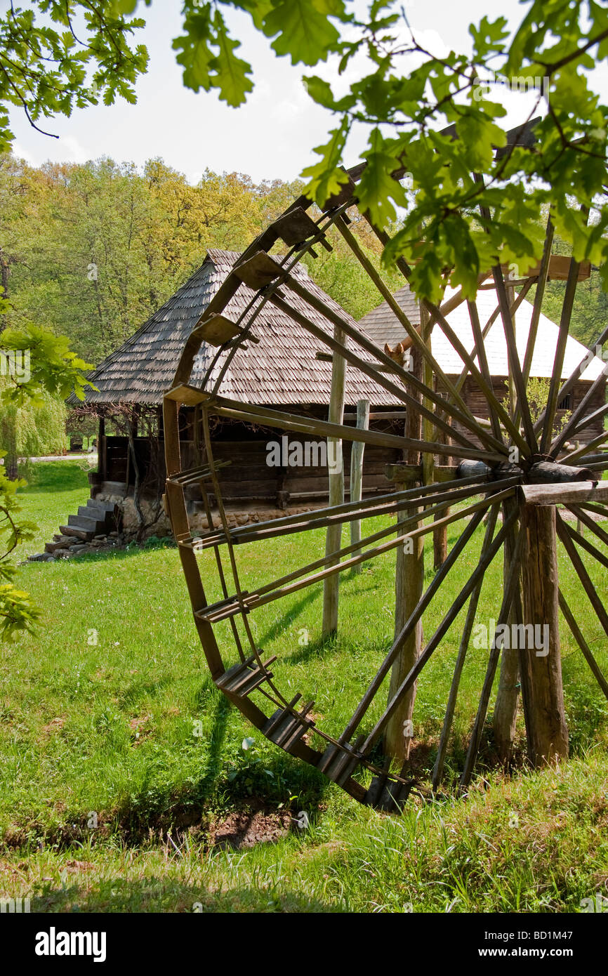 Romania's Museum of Traditional Folk Civilization water wheel and dwellings at Sibiu in Transylvania Stock Photo