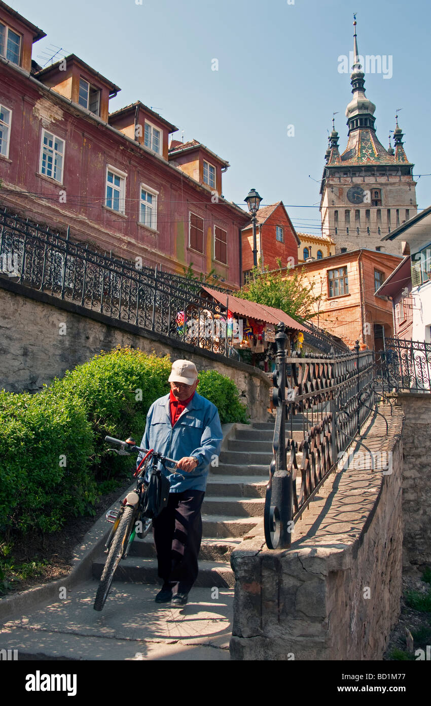 Stairs to medieval Romanian citadel town of Sighisoara (Schassburg in German) with clock tower above, in Transylvania Stock Photo