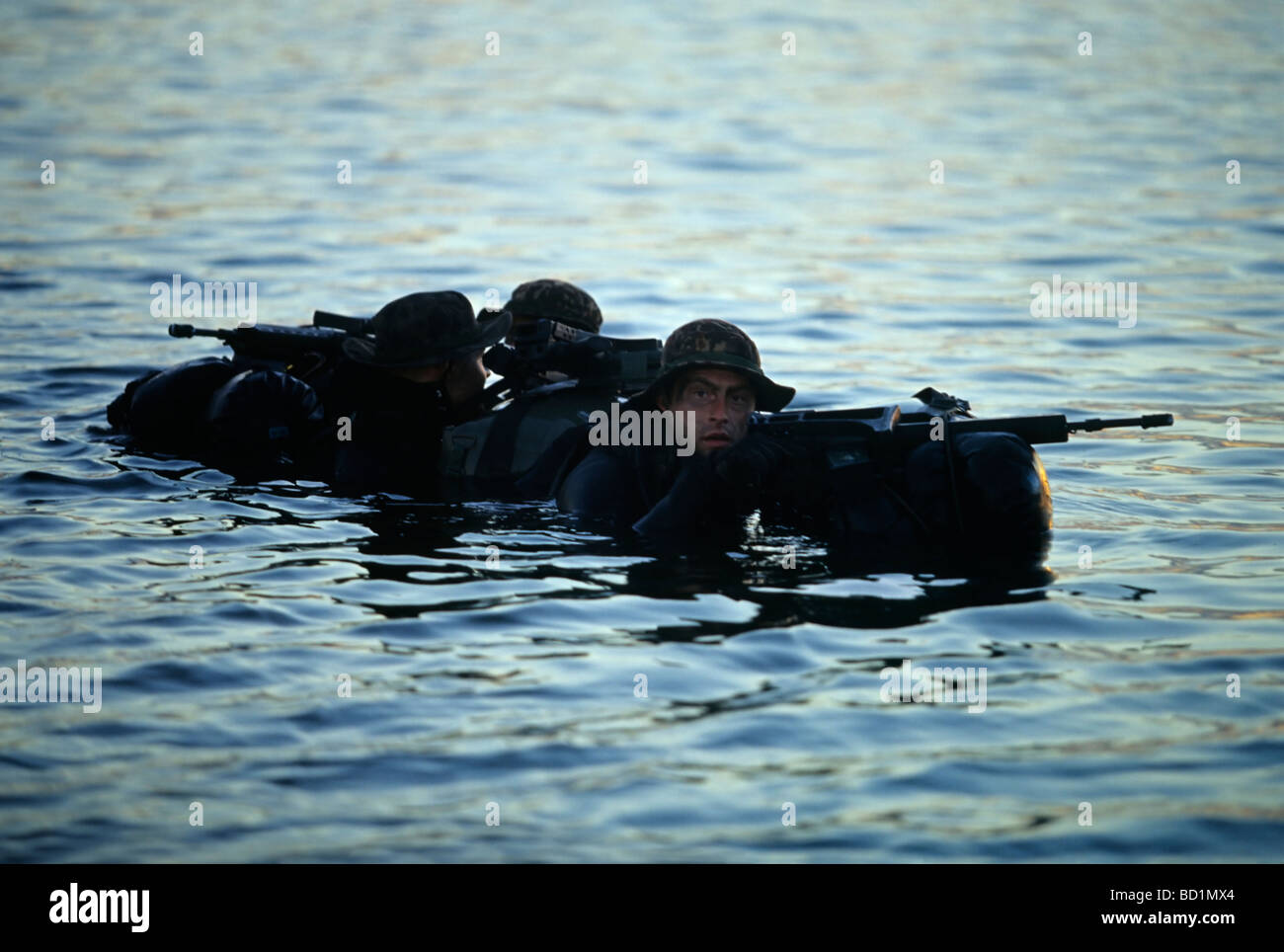 Armed Soldiers of the German special forces 'Kampfschwimmerkompanie' waiting on the surface of the sea for helicopter pickup, E Stock Photo