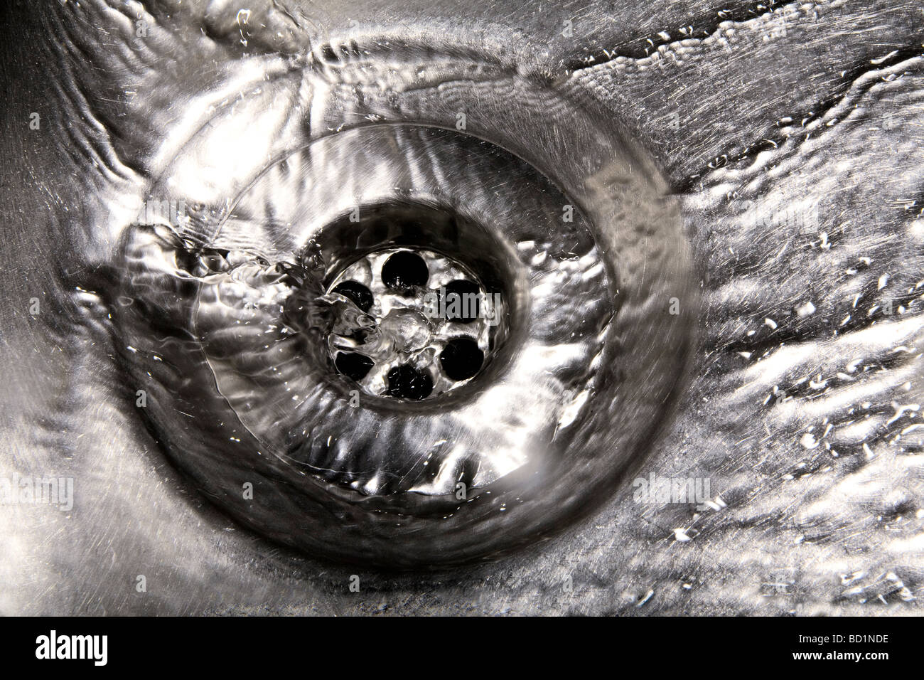 Water running down a plug hole Stock Photo