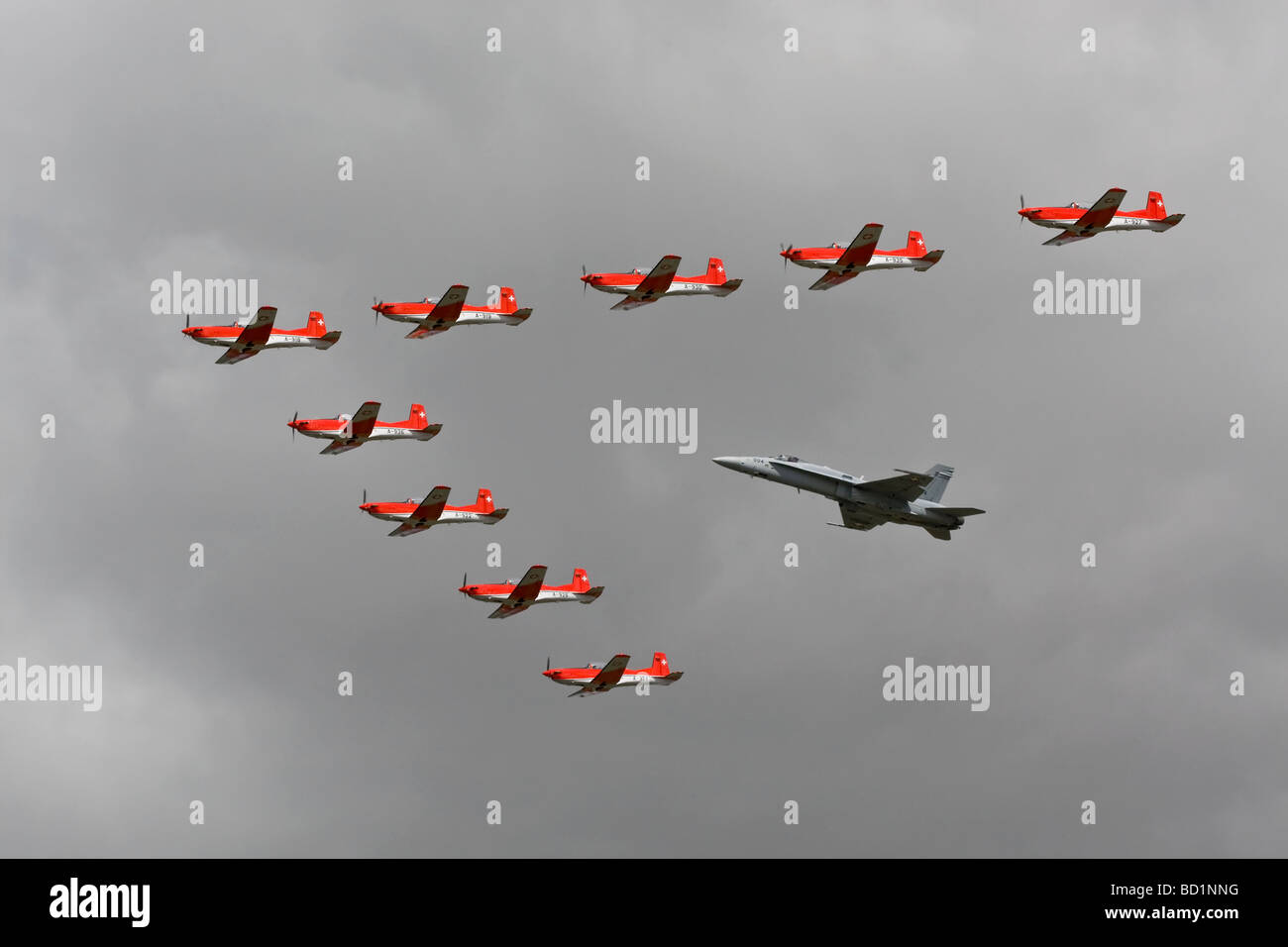 A close formation of Swiss air force Pilatus PC7 training aircraft along with an F18 Hornet Stock Photo