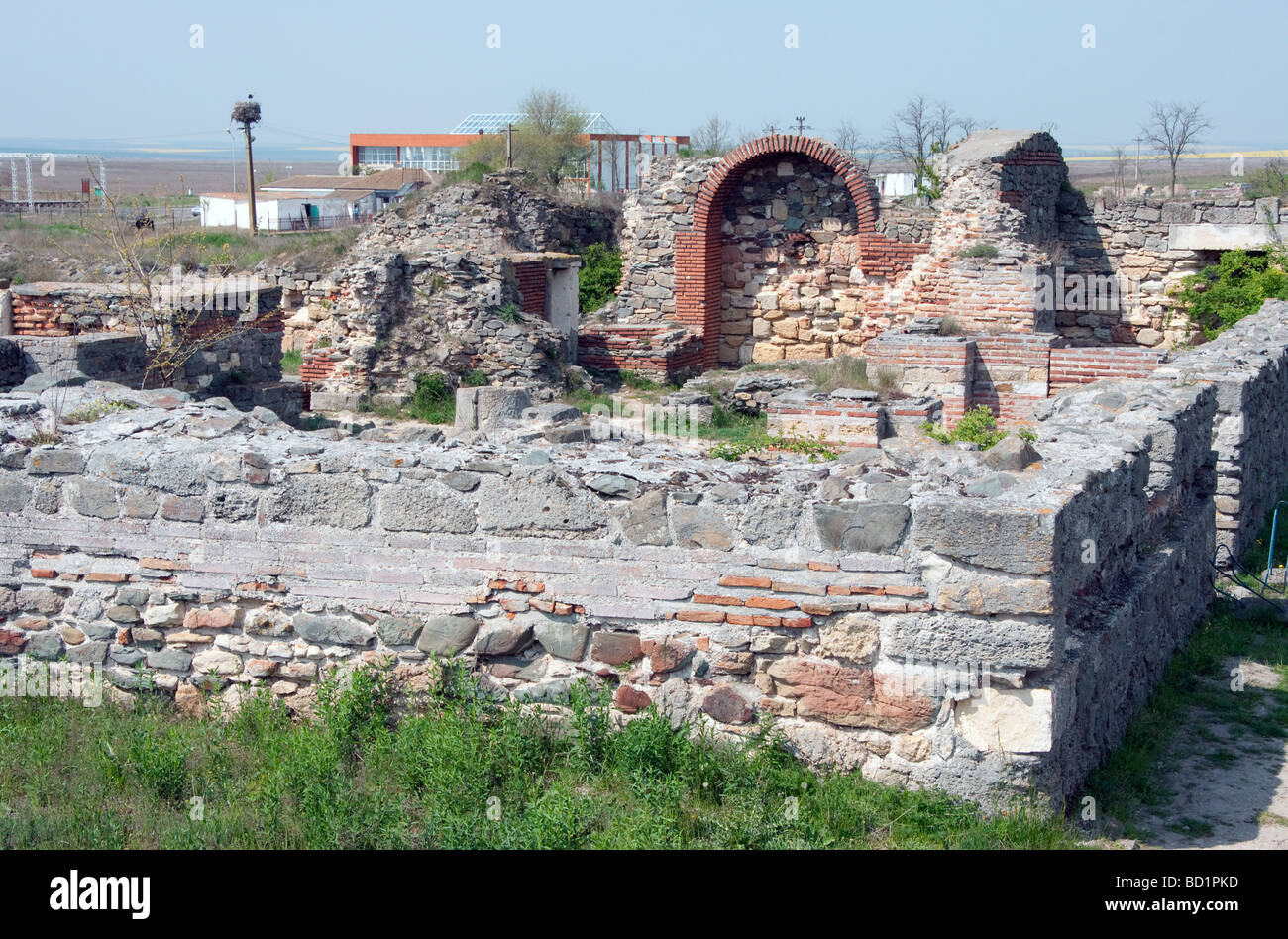 Romania's ancient Histria, or Istros, archaeological site's Roman frigidarium, with modern Histria Museum behind Stock Photo