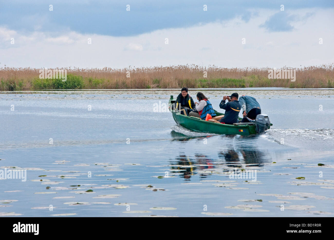 Romanian family on holiday boating in the Danube Delta Stock Photo