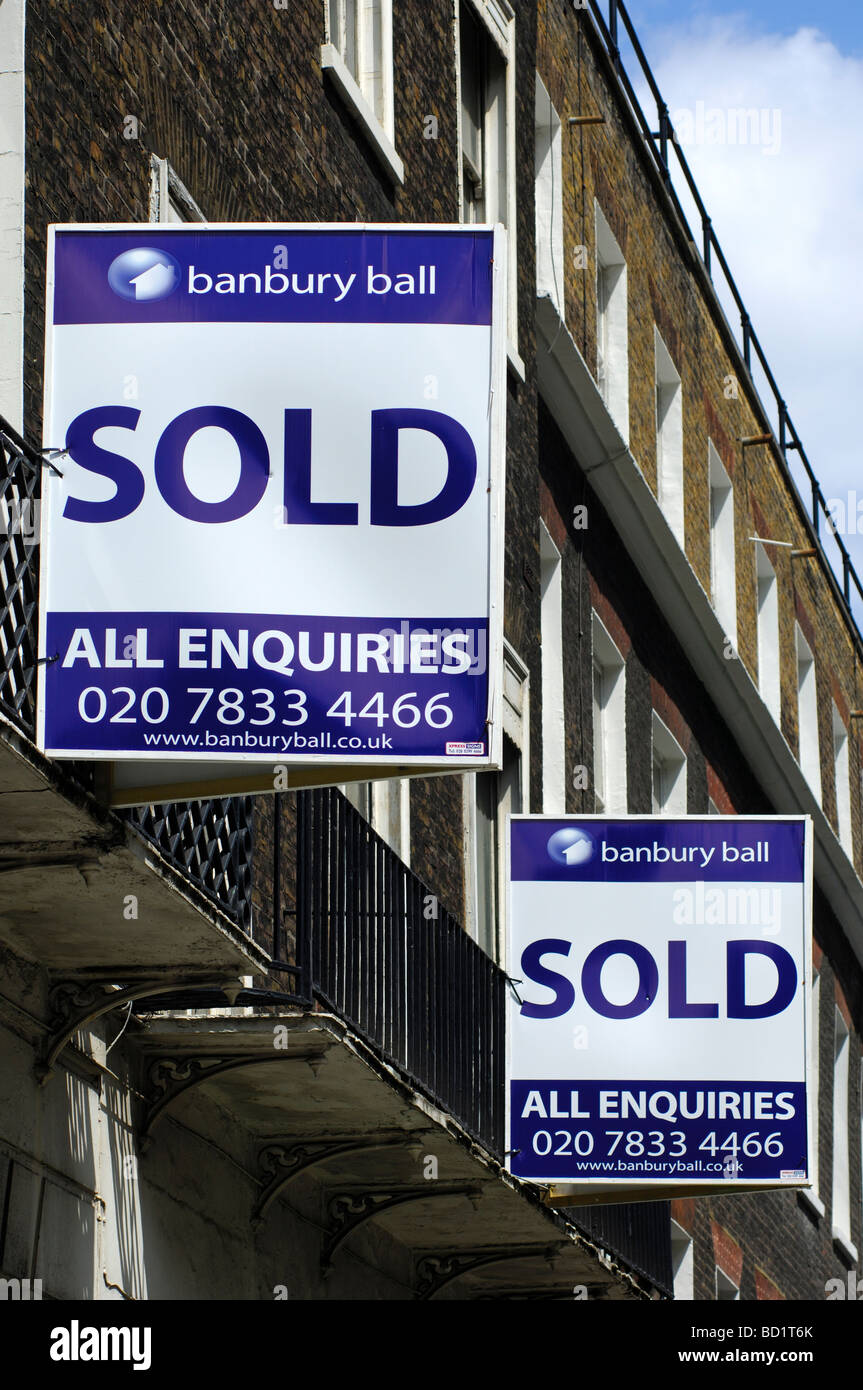 Sold signs of the Banbury Ball estate agents at a building London