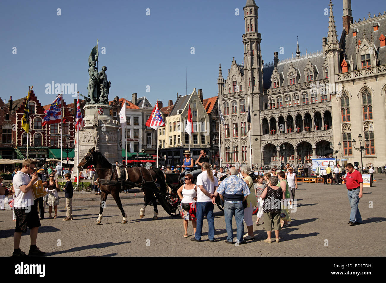 Carriage with tourists on the Grote Markt square with Provinciaal Hof Provincial Court building  in bruges Stock Photo