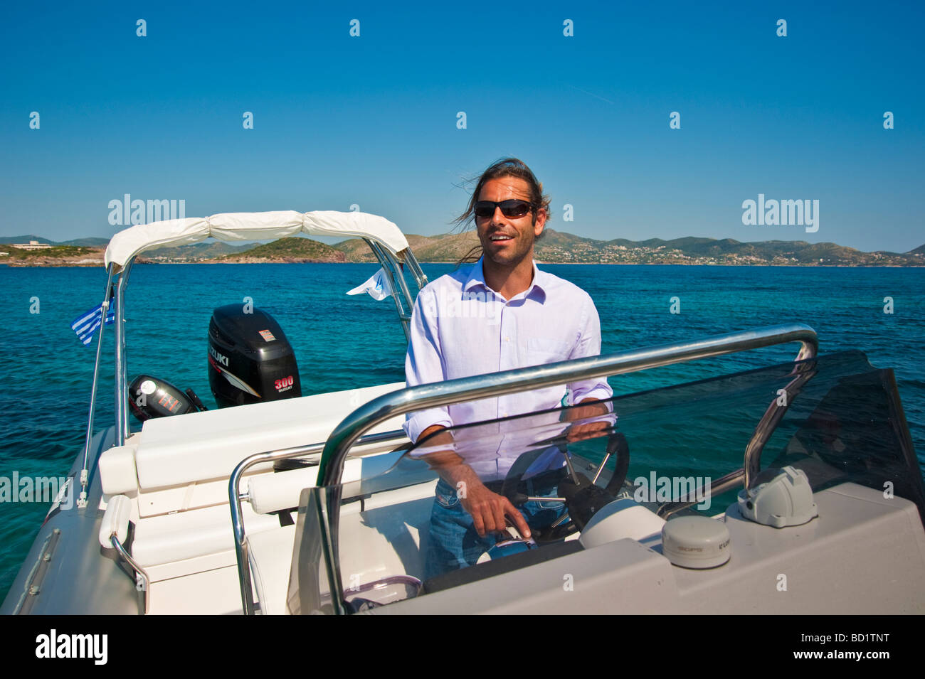 Man on helm of an inflatable boat in the Mediterranean Sea in Greece