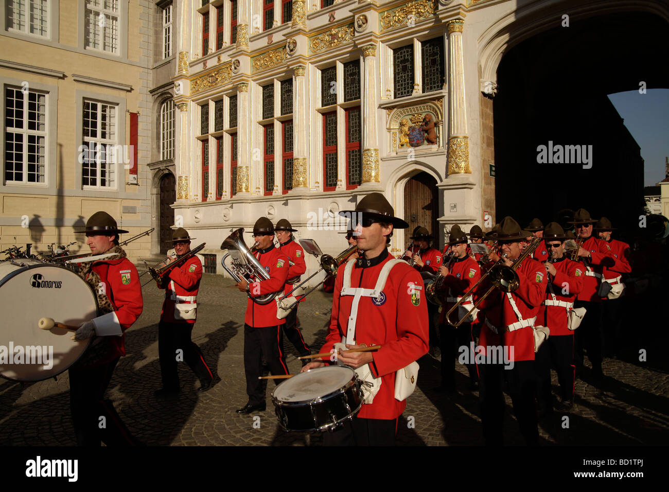 Brass band Groep Sint Leo marching through the historic center of Bruges Belgium Europe Stock Photo