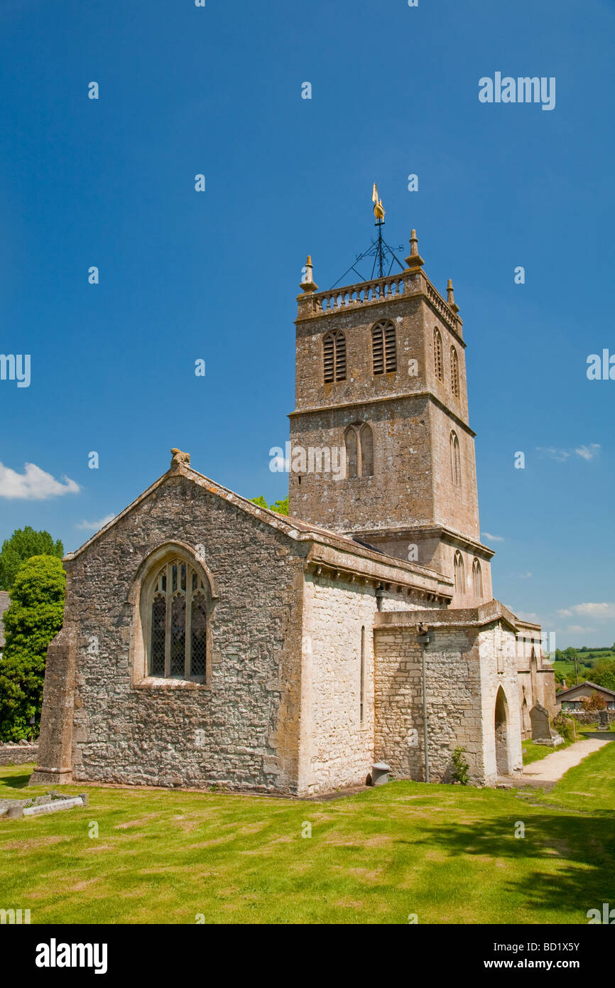 A old English church on a summers day with blue sky and green grass. Stock Photo