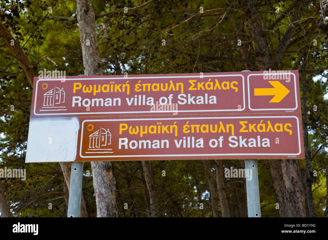 Brown tourism sign to Roman villa with mosaics in centre of Skala on the Greek island of Kefalonia Greece GR Stock Photo