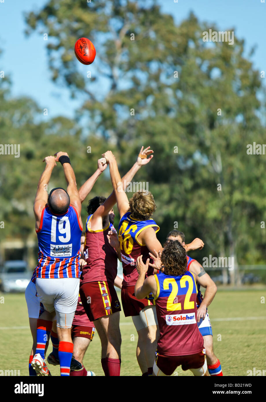 Australian Rules Football being played by two teams in a competition