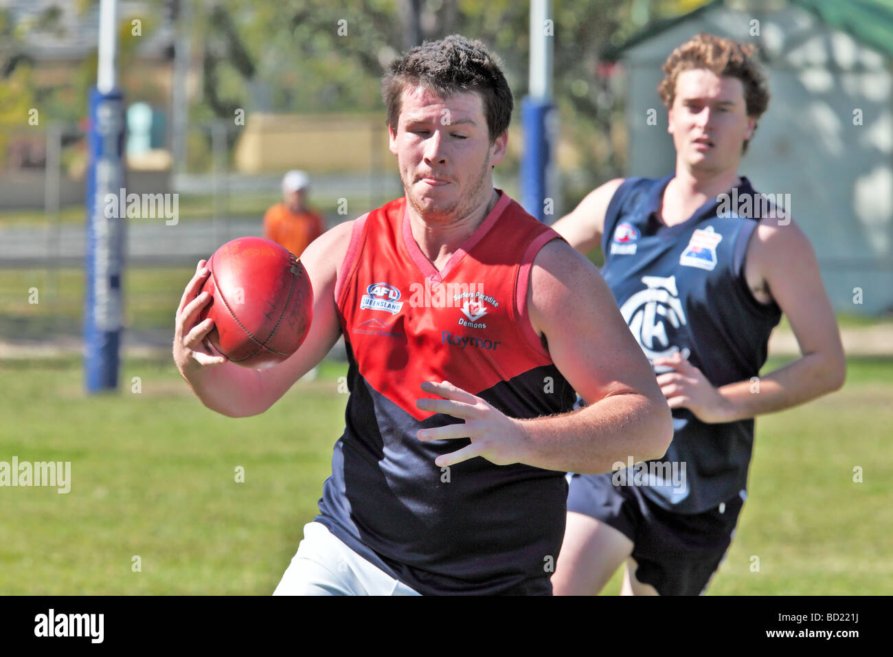 Australian Rules Football being played by two teams in a competition