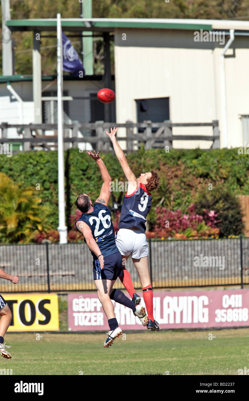Australian Rules Football being played by two teams in a competition