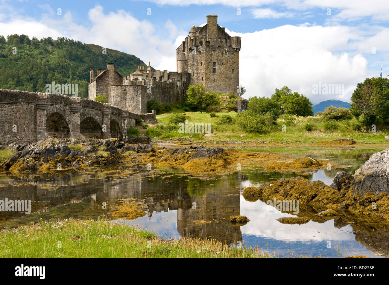 Eilean Donan Castle reflected in Loch Duich Highlands on a sunny day in Scotland July 2009 Stock Photo