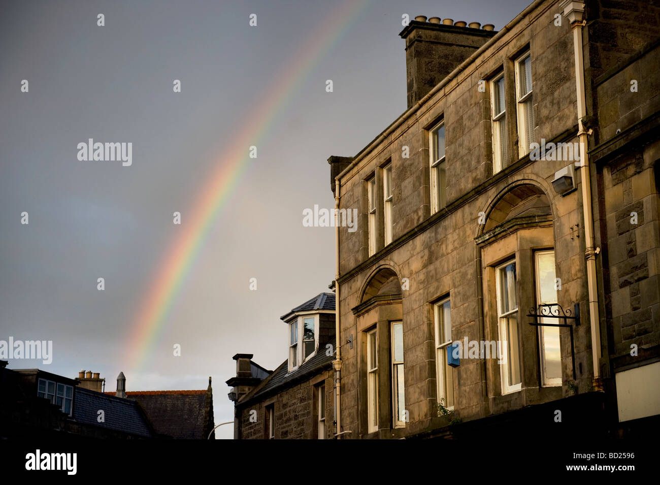 A rainbow forms over Elgin, Moray, Scotland on a summer's evening July 2009 Stock Photo