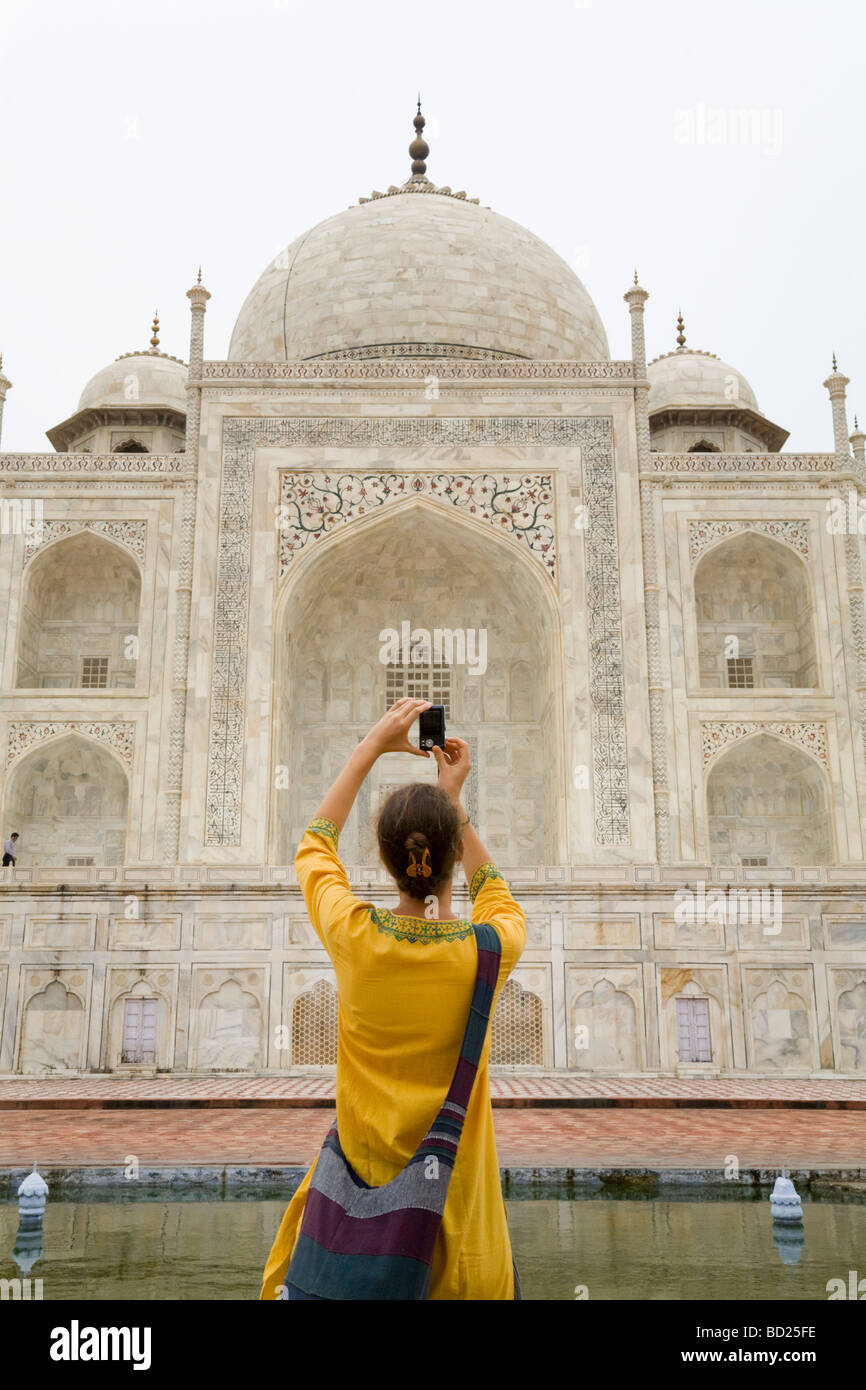 Woman tourist takes a photo of the west side of the Taj Mahal mausoleum from the river-front terrace (Chameli Farsh) Agra. India Stock Photo