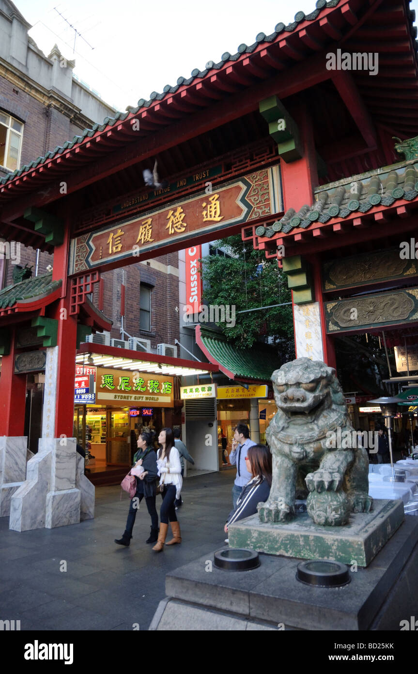 Chinese lion guarding the gate (paifang) which indicates entry into the main part of Chinatown. Stock Photo