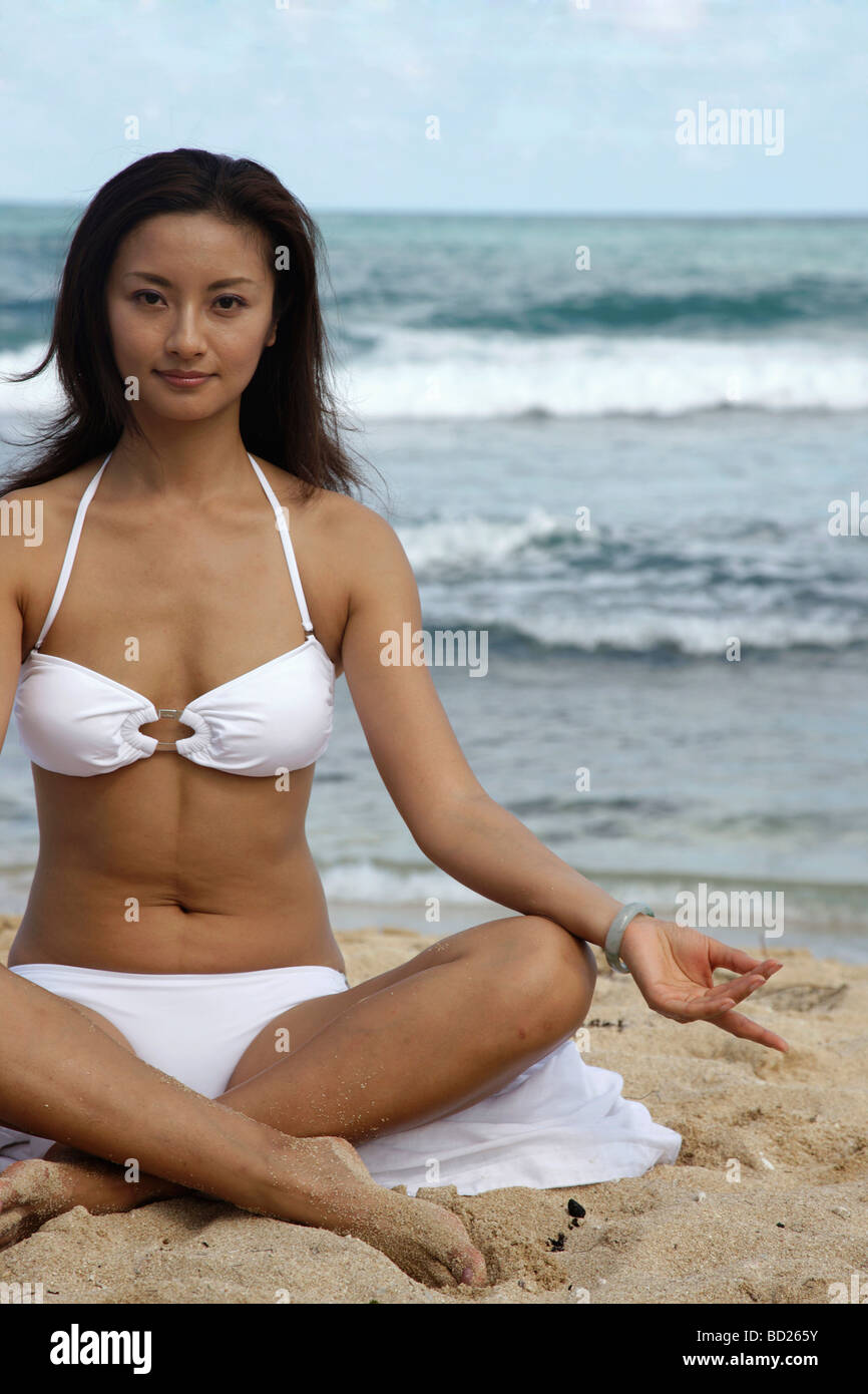 Chinese woman doing yoga on the beach,Caribbean Stock Photo - Alamy