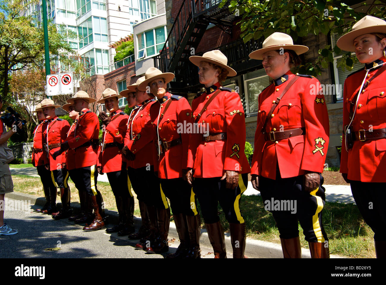 Royal Canadian Mounted Police in red serge ceremonial uniforms preparing to participate in Vancouver Gay Pride parade Stock Photo