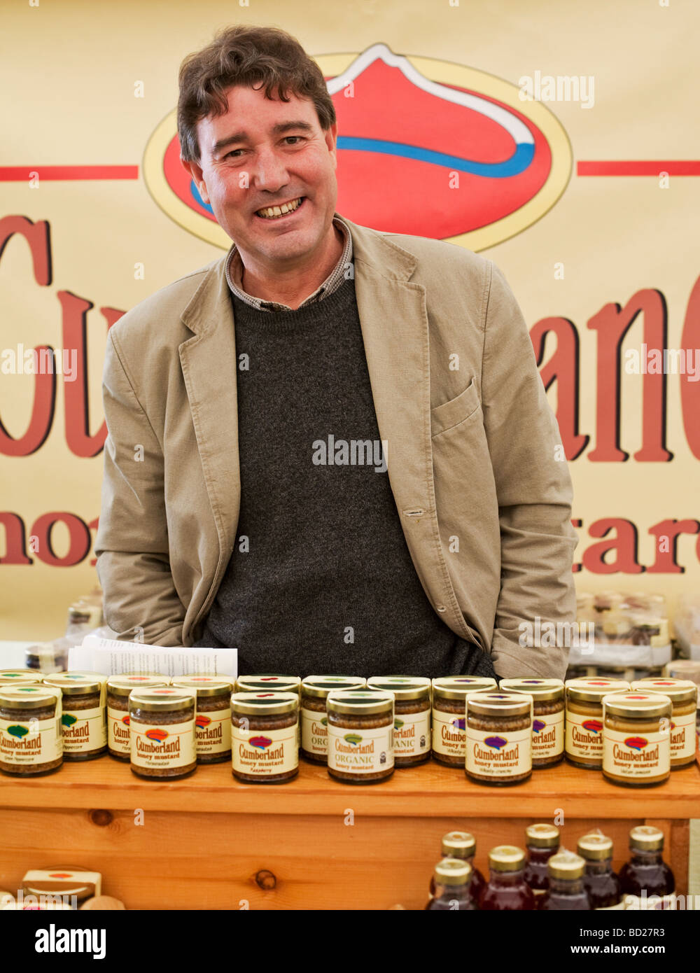 Man selling Cumberland Honey Mustard at a Craft and Food Fair, Northumberland, England Stock Photo