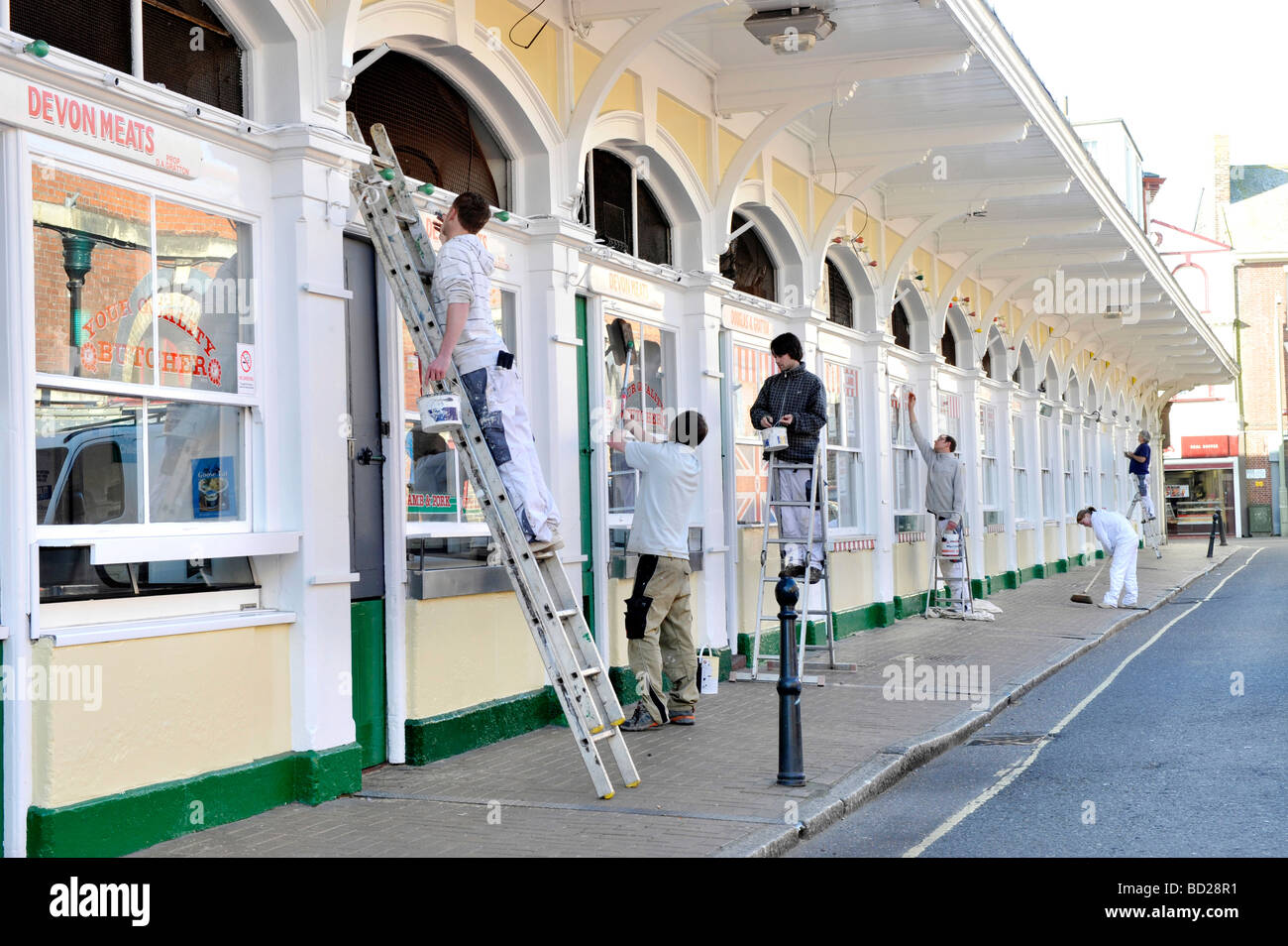 Historic Butchers row in Barnstaple Devon gets a paint makeover by workers in the build up to Easter Stock Photo