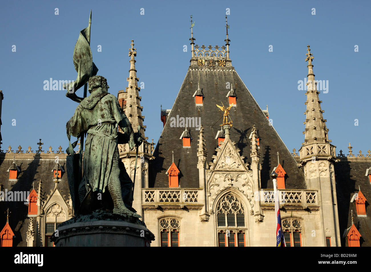 statue of the  heroes Jan Breydel and Pieter de Coninck on the Grote Markt square with Provinciaal Hof  in Bruges Stock Photo