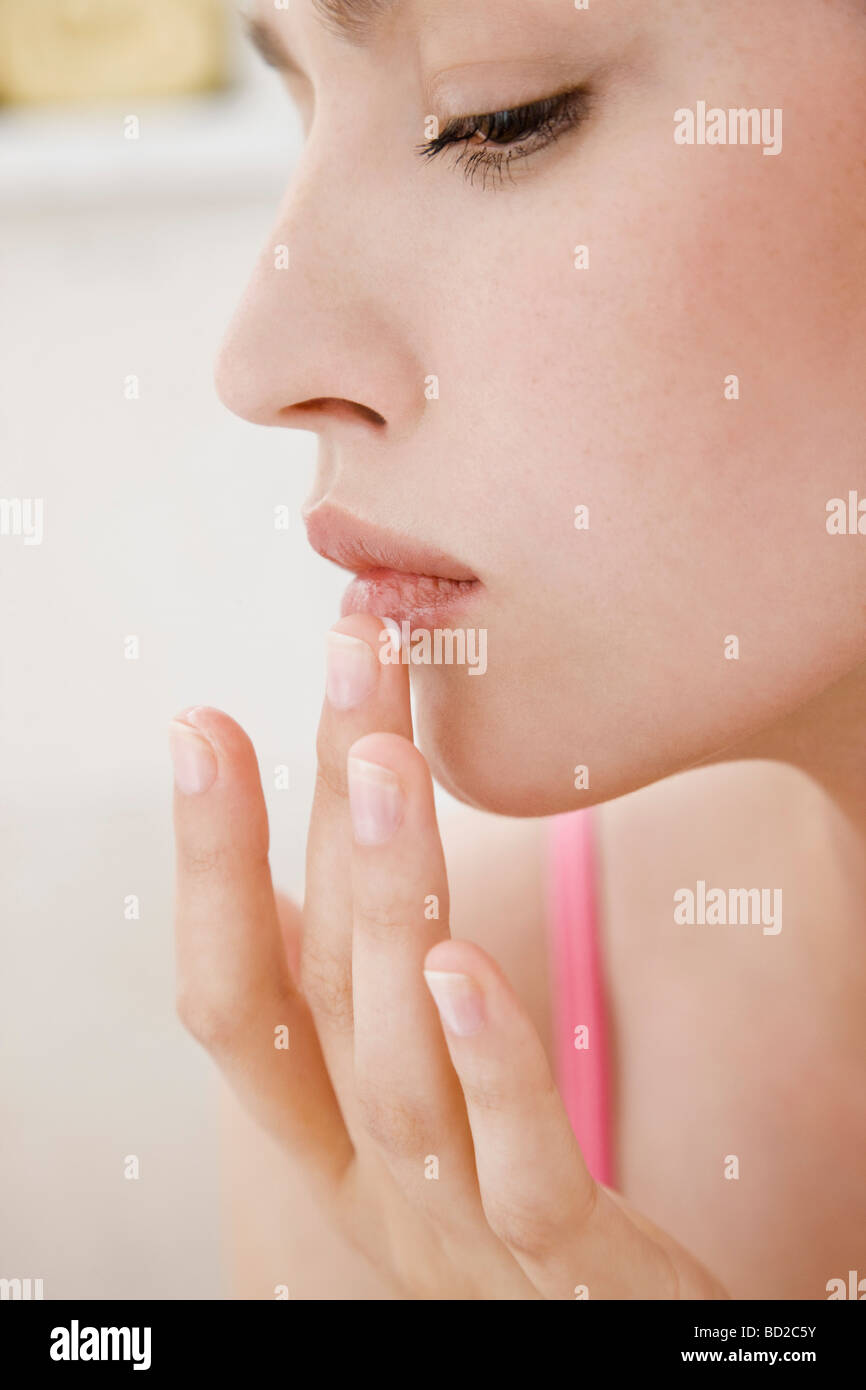 woman applying ointment for cold sore Stock Photo Alamy