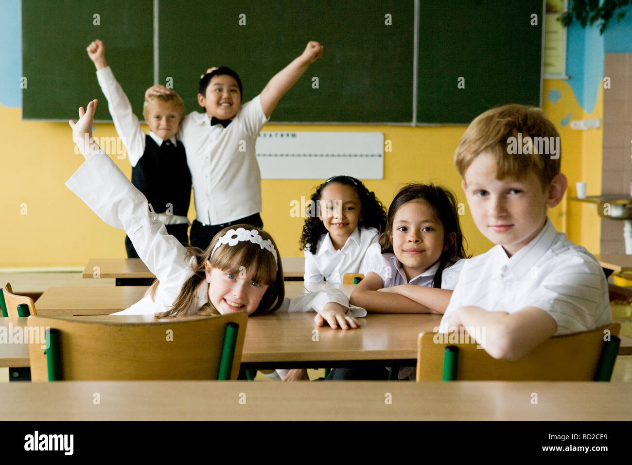 Happy children in classroom Stock Photo