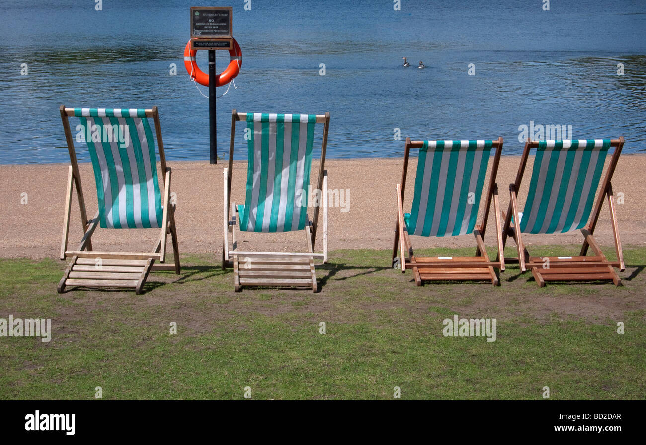 Deckchairs by the Serpentine in Hyde Park London UK Stock Photo