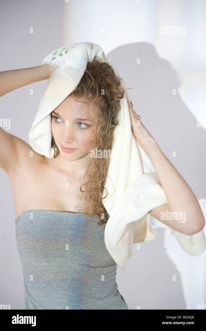 young woman drying hair with towel Stock Photo Alamy