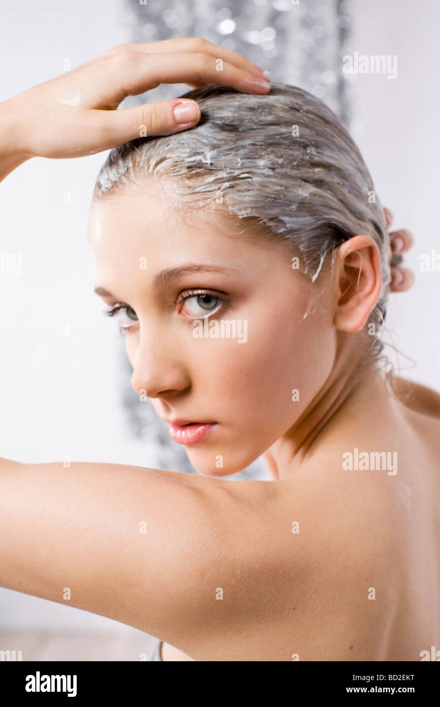 young woman with conditioner in hair Stock Photo Alamy