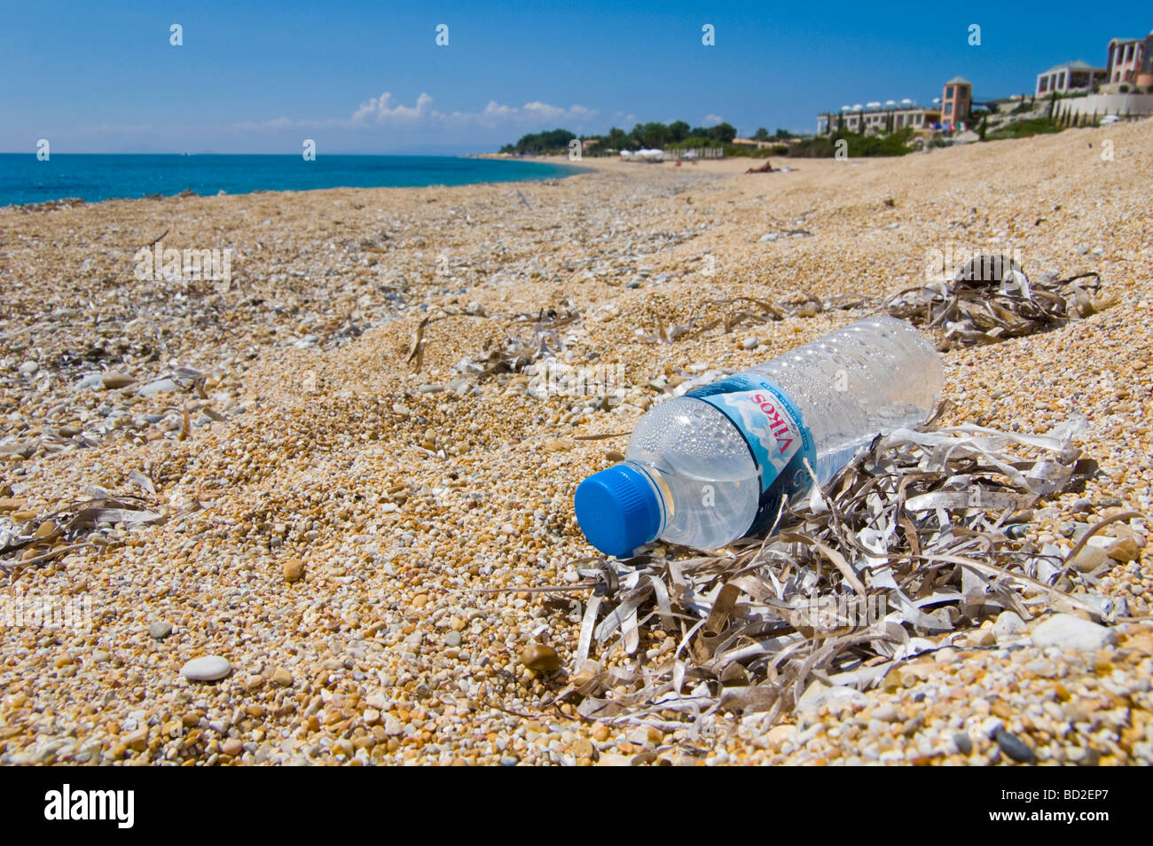 Plastic water bottle dropped as litter on beach at Skala on the Greek island of Kefalonia Greece GR Stock Photo