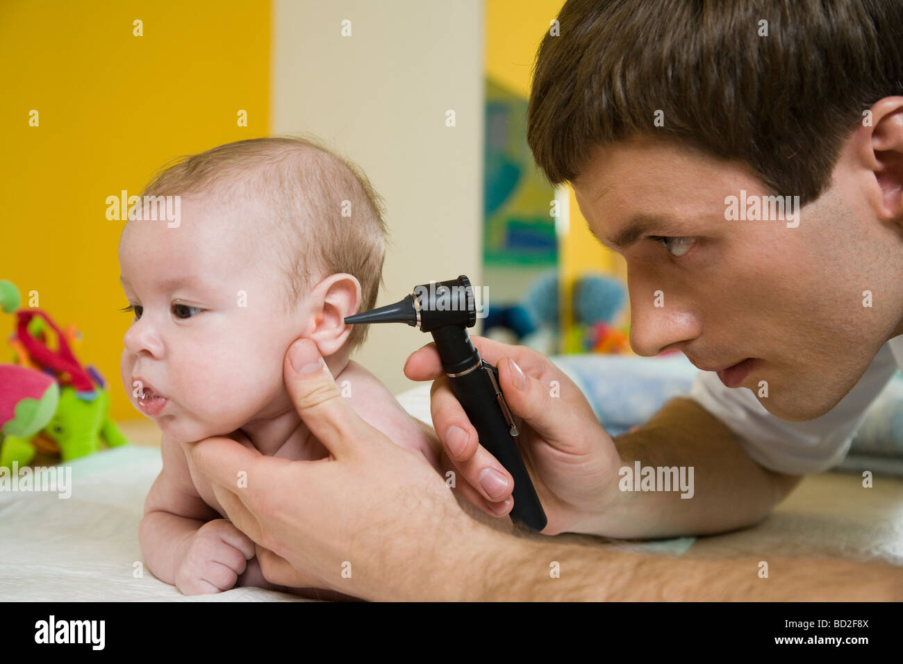 Doctor Examining Infant With Otoscope Stock Photo Alamy Doctor Examining Infant With Otoscope Stock Photo Alamy