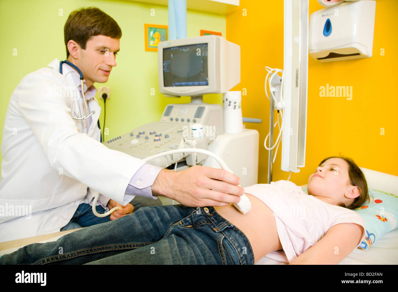 Doctor examining stomach girl hires stock photography and images Alamy