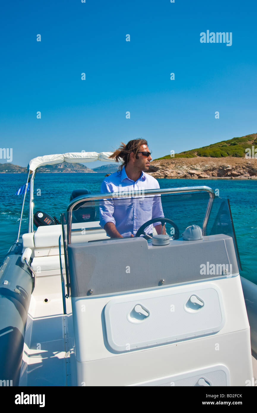 Man on helm of an inflatable boat in the Mediterranean Sea in Greece