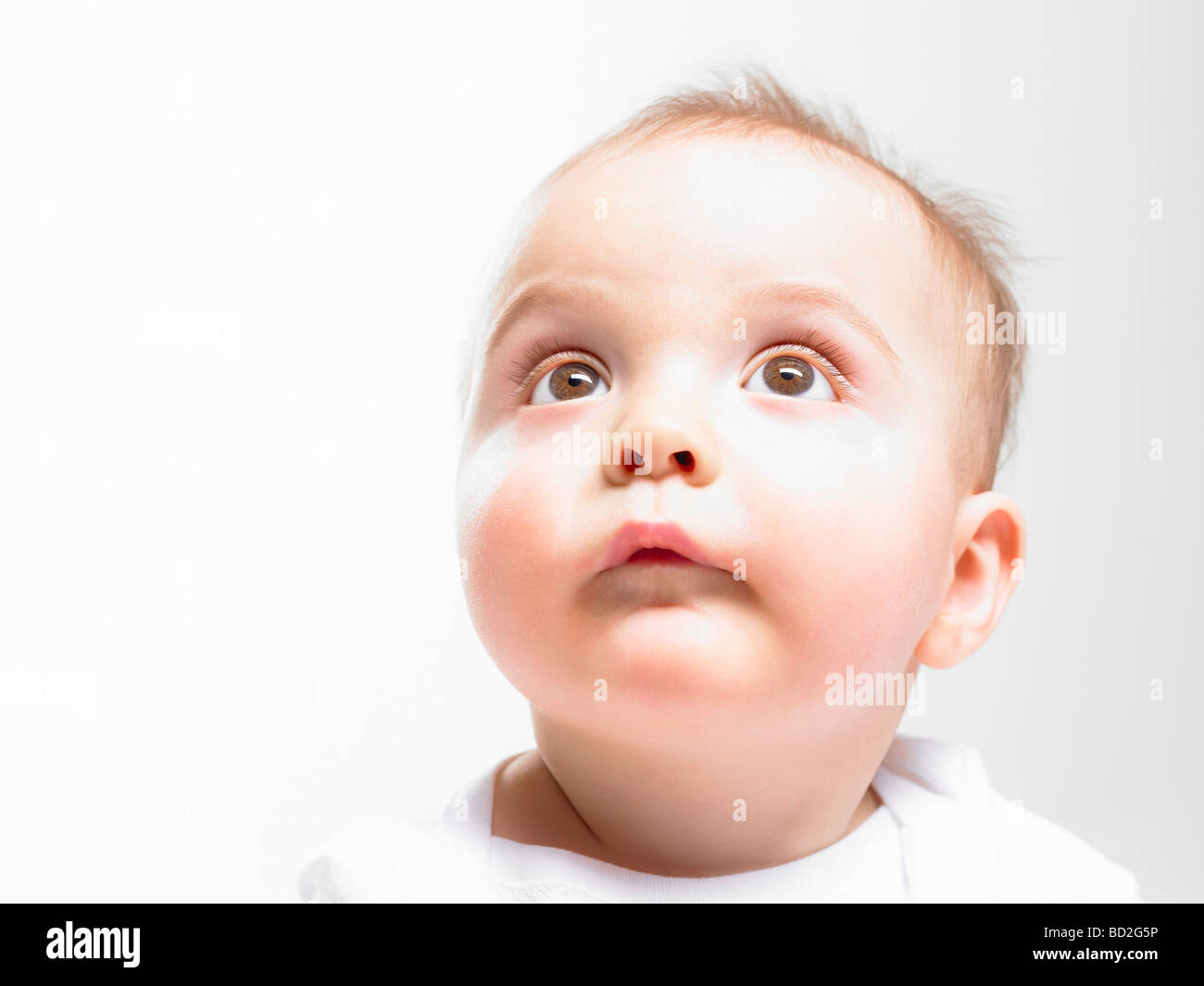 Baby looking towards ceiling Stock Photo Alamy