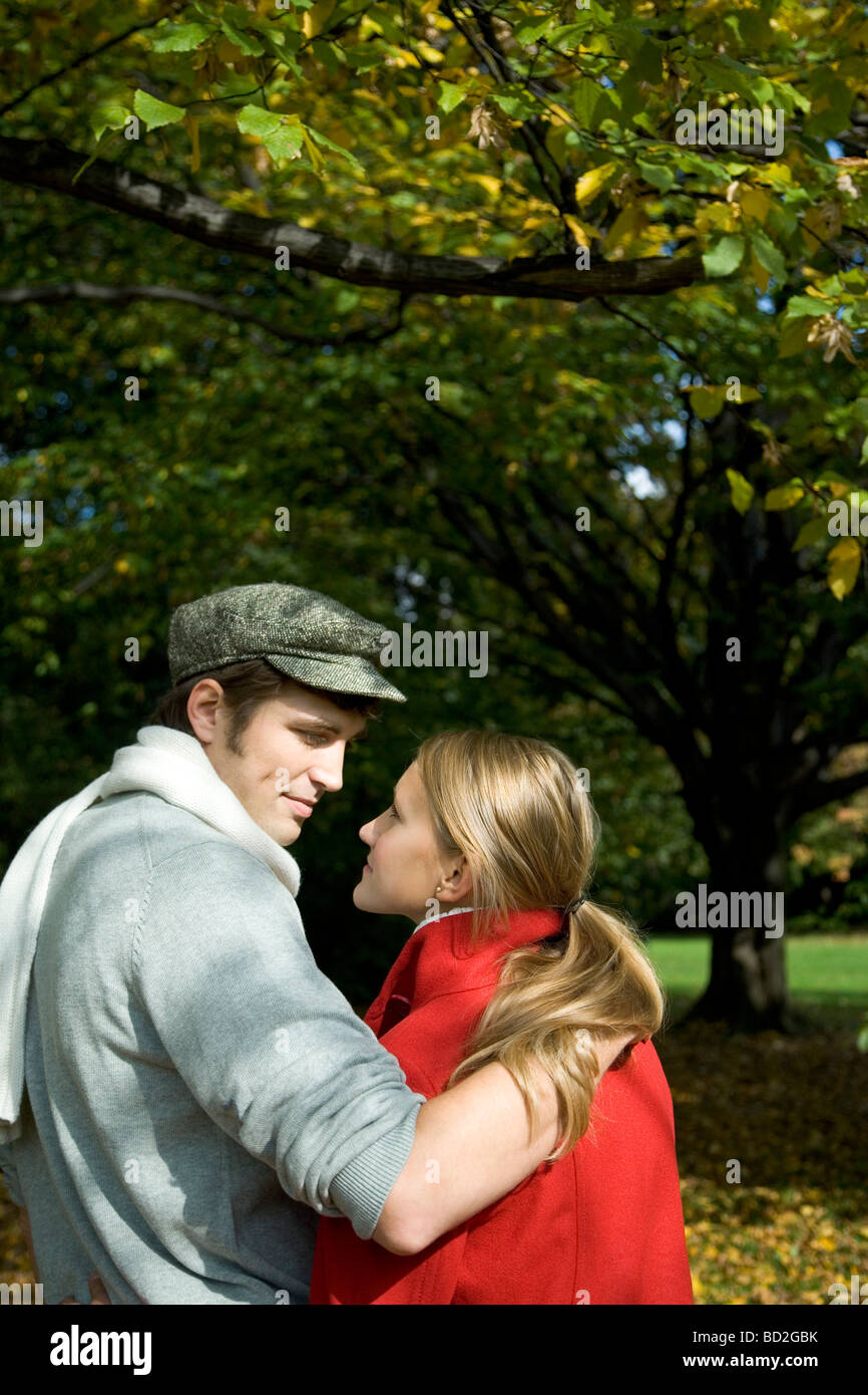 Couple hugging in park Stock Photo - Alamy