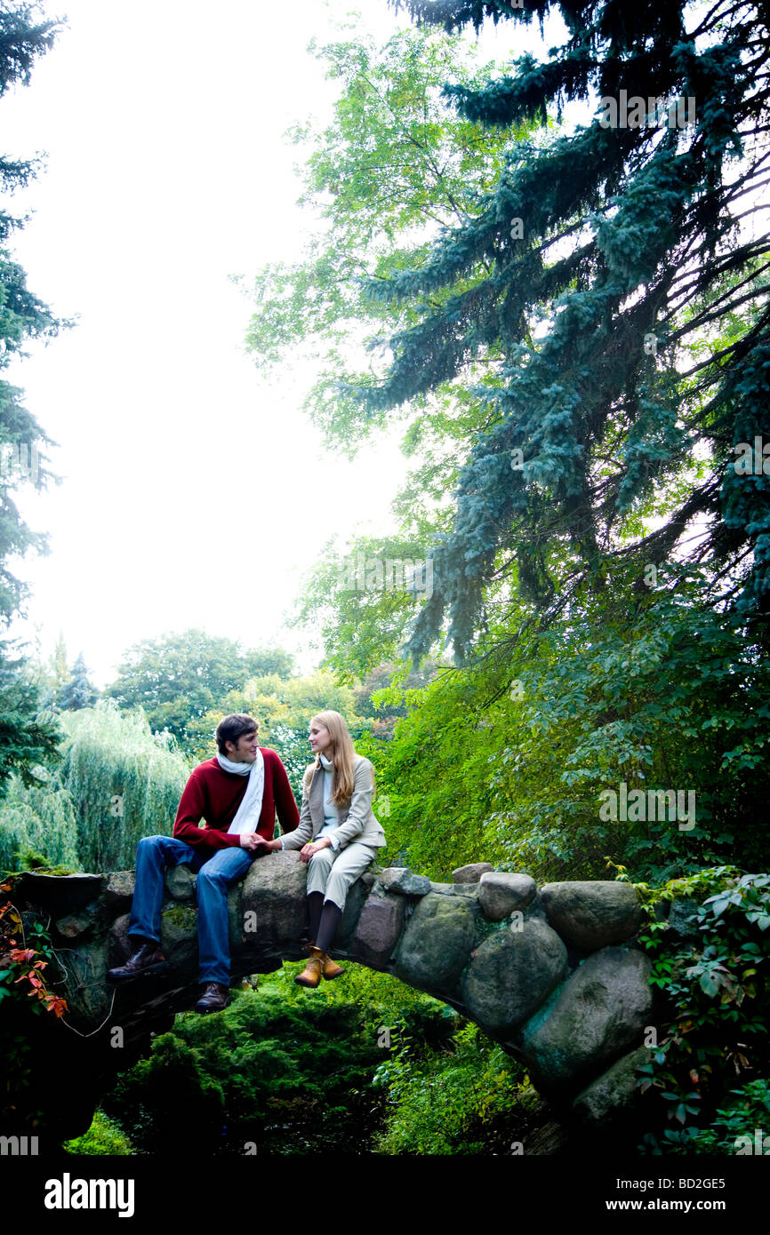 Loving couple on bridge in park Stock Photo - Alamy