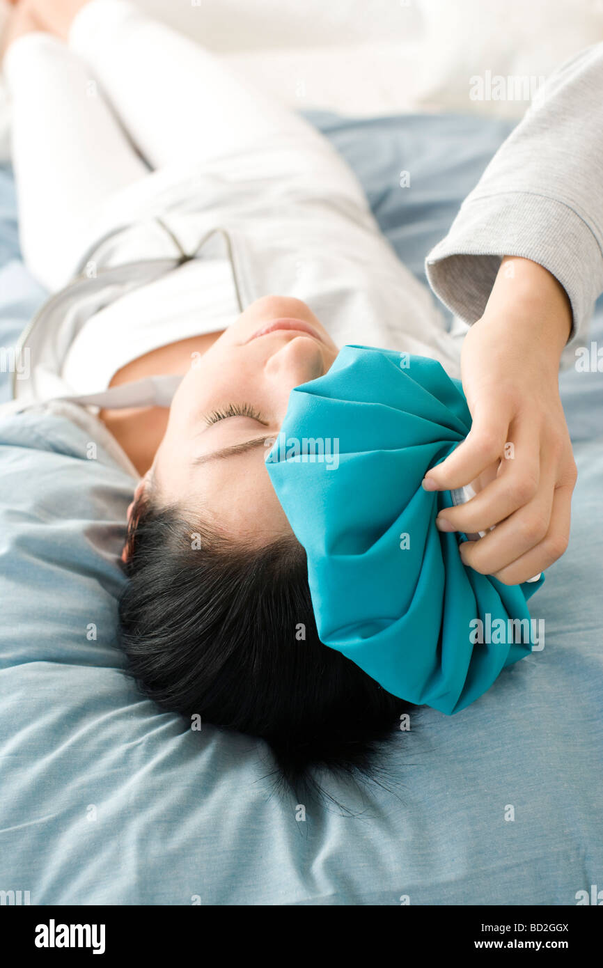 Woman using hot water bottle Stock Photo Alamy