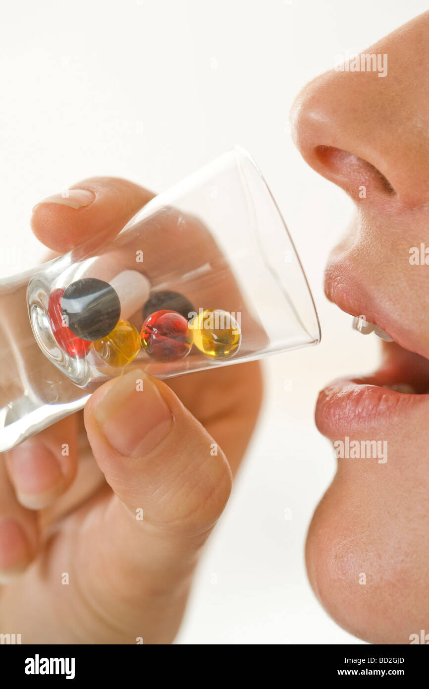 Woman taking pill Stock Photo