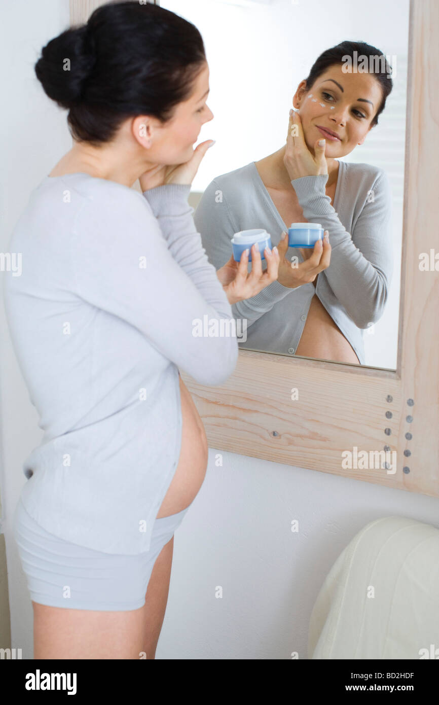 Pregnant woman applying face cream Stock Photo Alamy