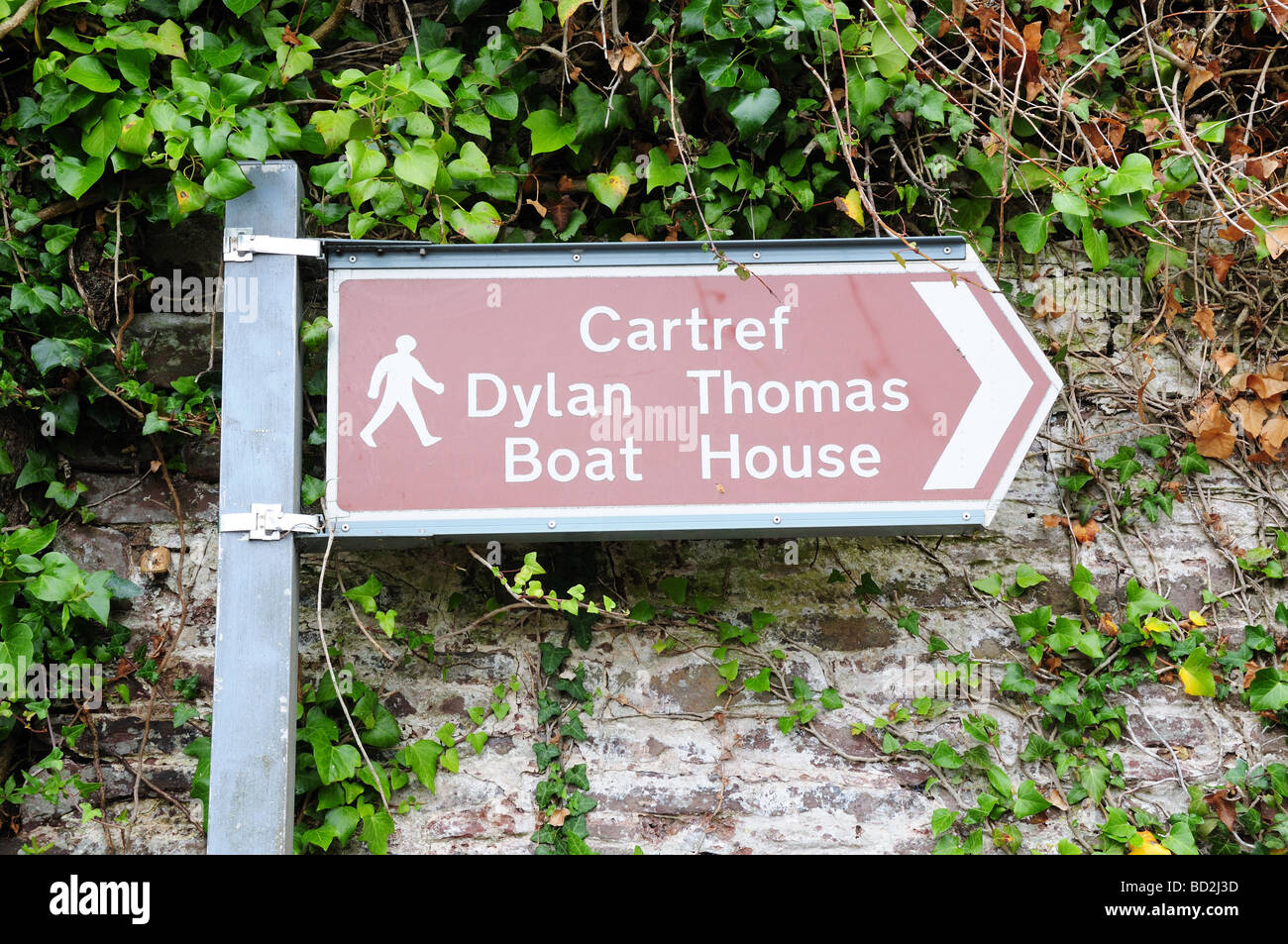 Signpost showing the way to Dylan Thomas Boat House Laugharne  Carmarthenshire Wales Stock Photo