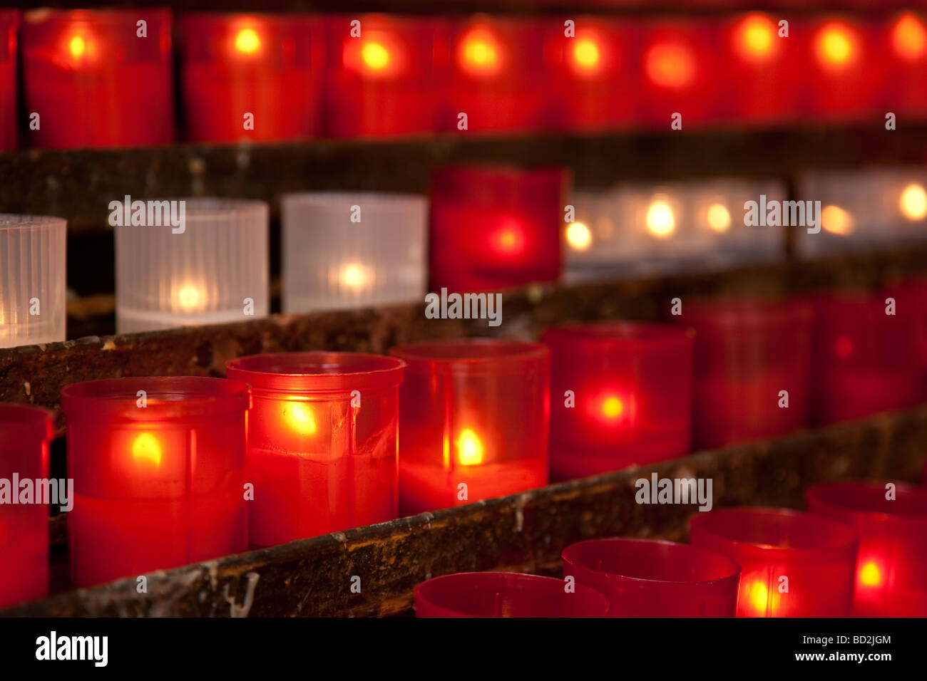 Burning candles for promise payment in catholic church Stock Photo
