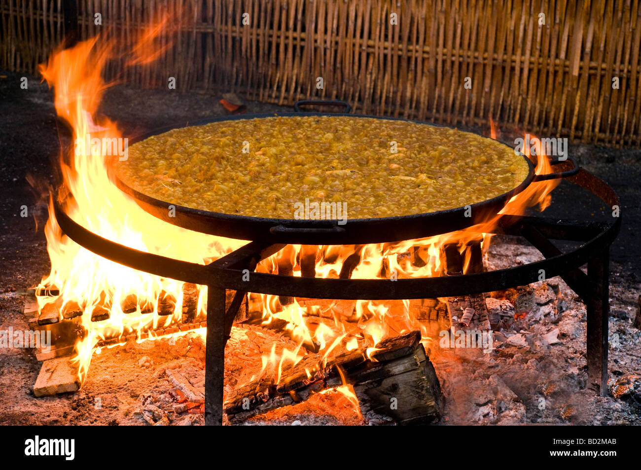 Paella Cooking in a large pan on the Burriana beach in Nerja Costa del Sol Spain Stock Photo