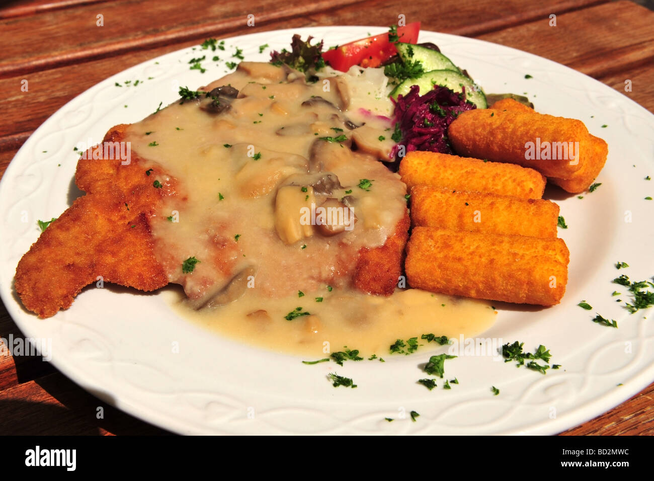 Classic German dinner of Schnitzel cutlet served with a mushrom sauce