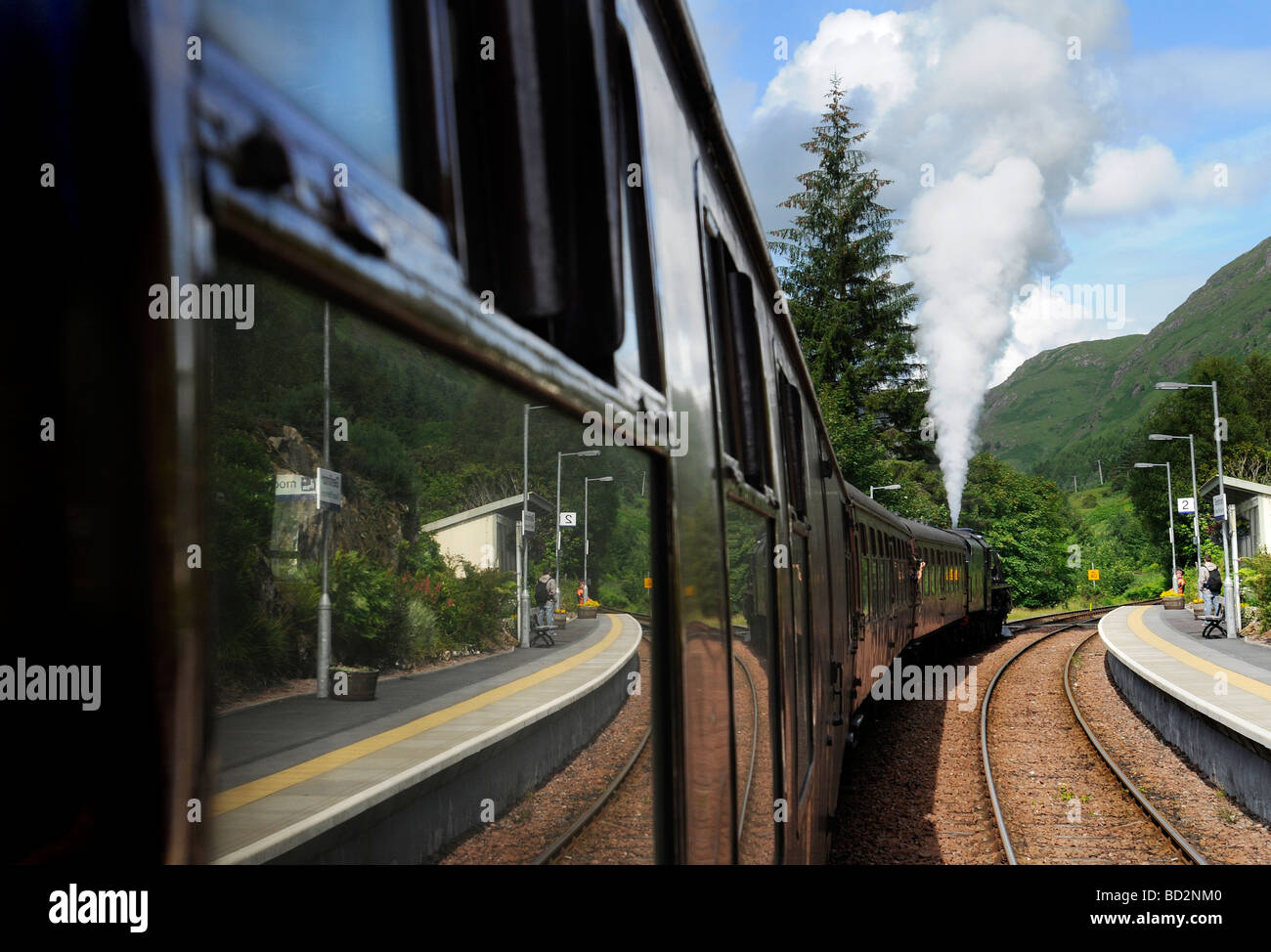 Stopping at Glenfinnan station during the Jacobite Steam train Journey from Fort William to Mallaig in Scotland Stock Photo