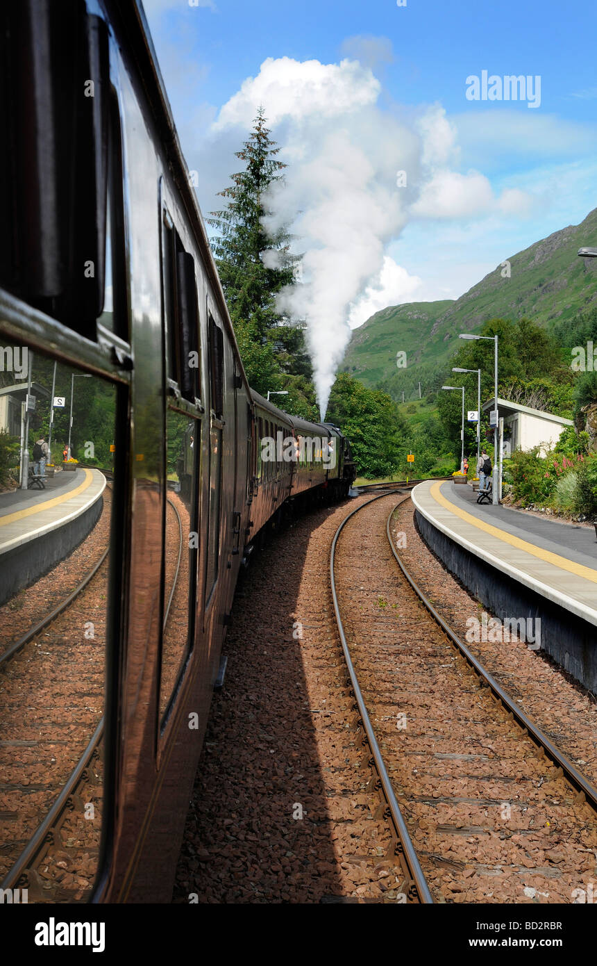 Stopping at Glenfinnan station during the Jacobite Steam train Journey from Fort William to Mallaig in Scotland Stock Photo